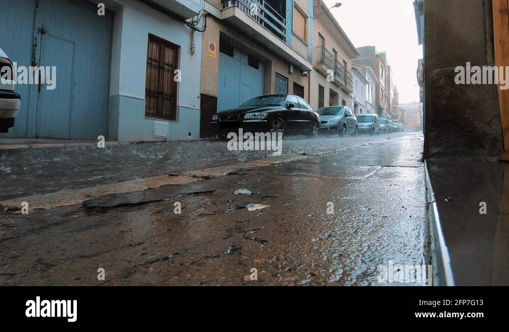 heavy-rain-pouring-down-and-flooding-empty-narrow-street-in-spanish