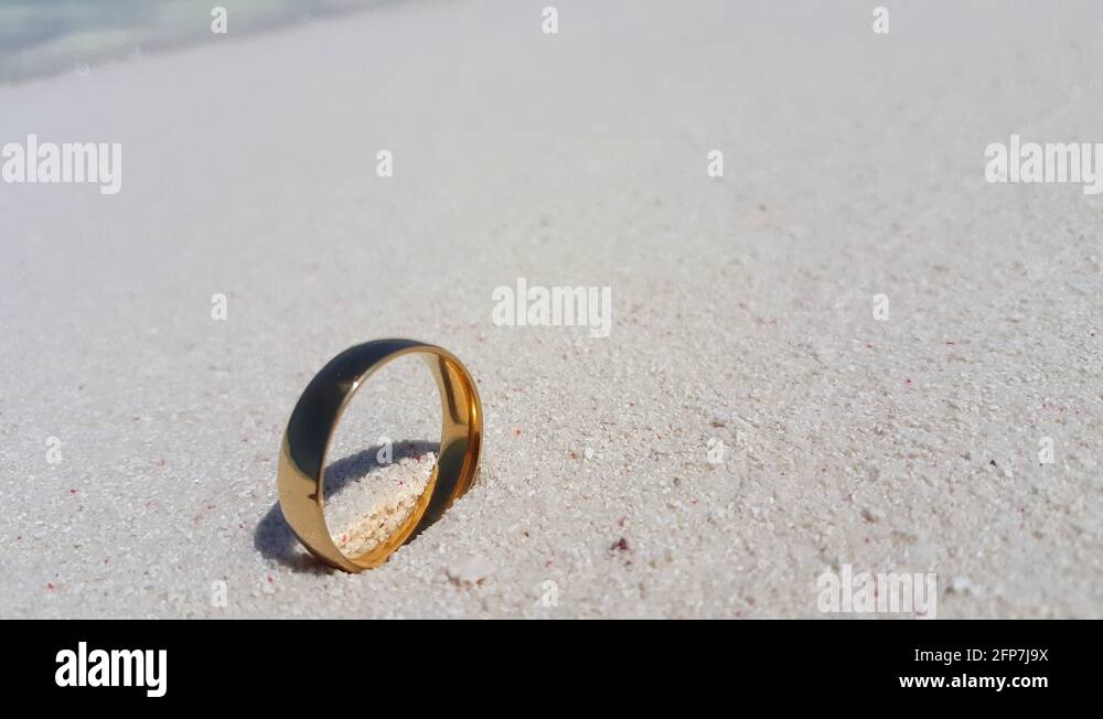 gold engagement ring in philippine seashore Stock Video Footage Alamy