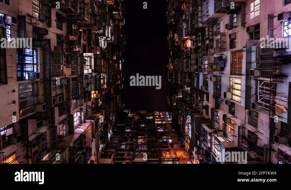 Old apartments complex in downtown Hong Kong time lapse at night Stock