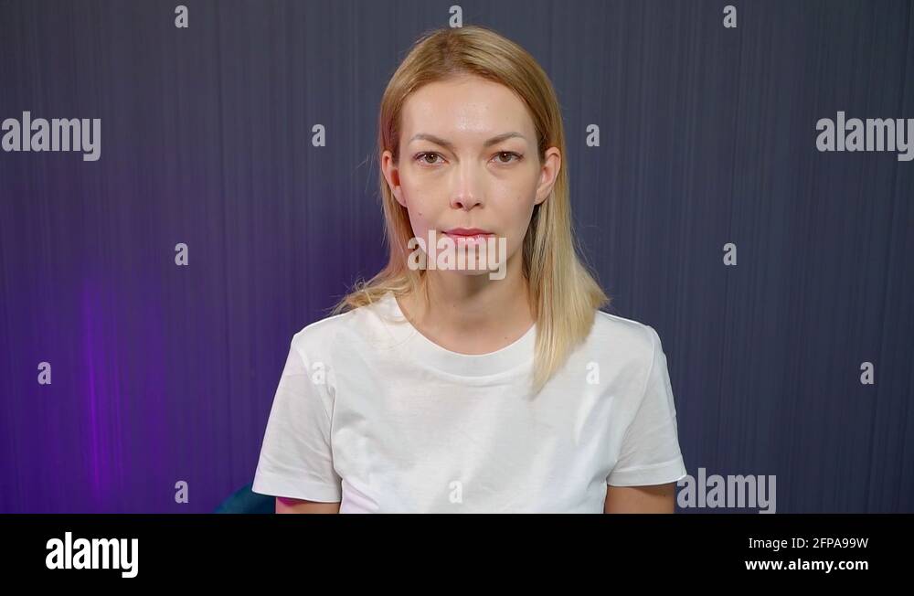 young blonde girl is doing exercises for the muscles of the face sitting on the Stock Video
