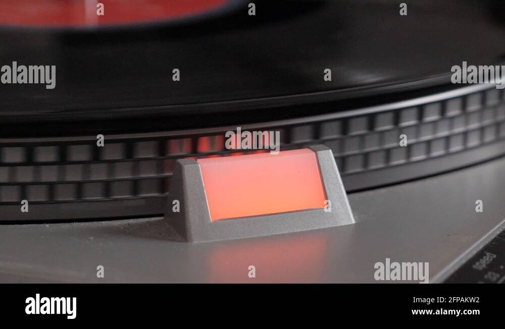 Slow motion of black vinyl record spinning on antique turntable and