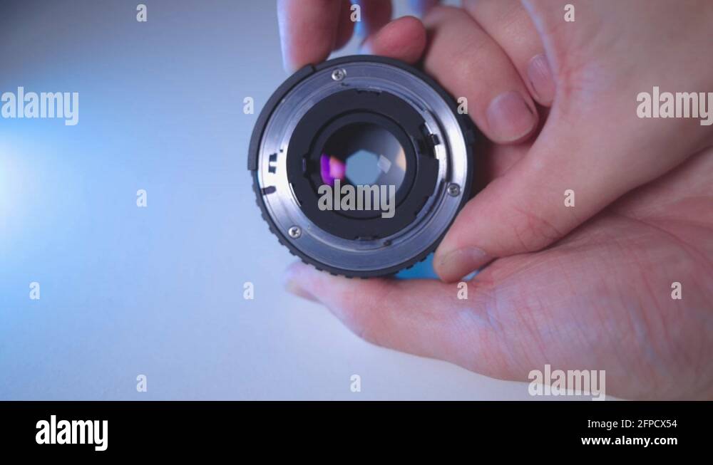 Hands Closing And Opening The Aperture Of Camera Lens close up Stock