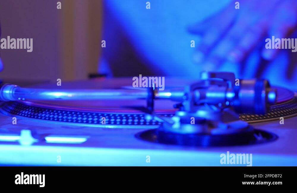 DJ Placing Vinyl On Turn Table And Placing Stylus To Begin Mixing Music