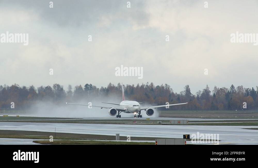 Emirates Boeing 777 takeoff on wet runway Stock Video Footage Alamy