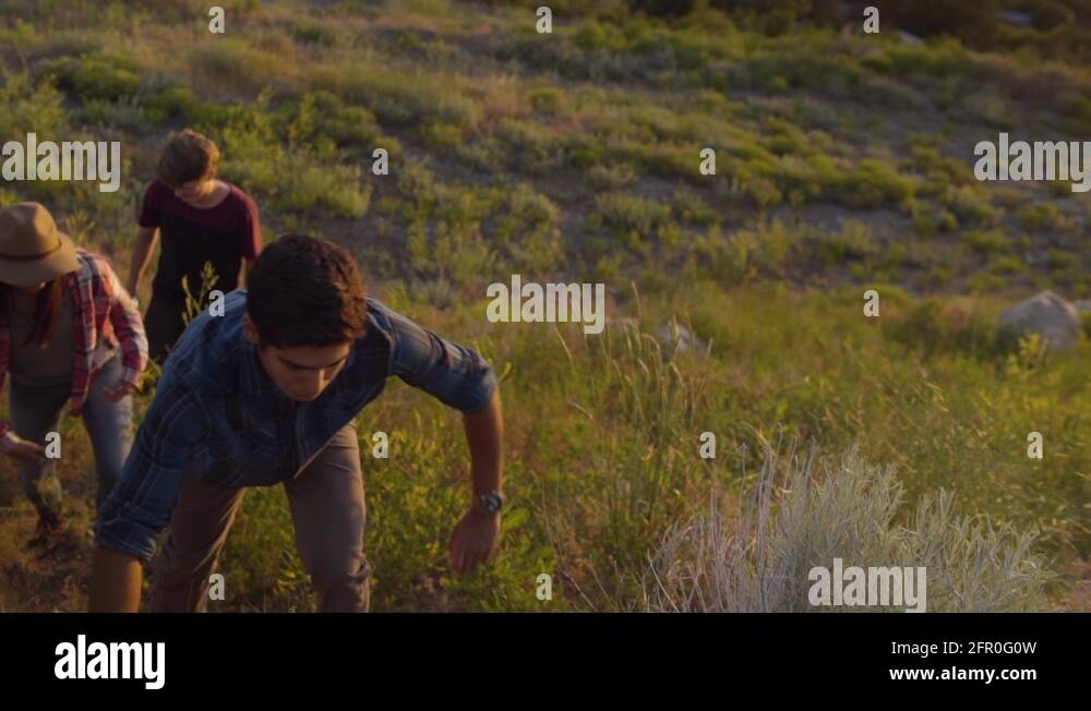 Group Of Friends Climb Uphill After Watching Sunset (Slow Motion Stock ...