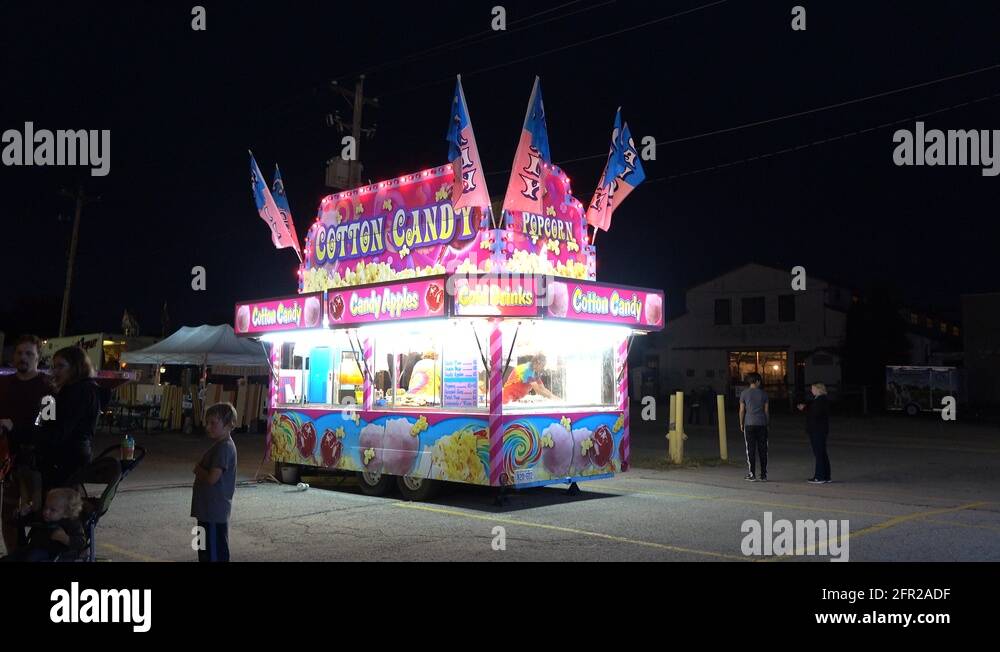 A Mobile Food Concession Trailer Selling Cotton Candy At Night Stock