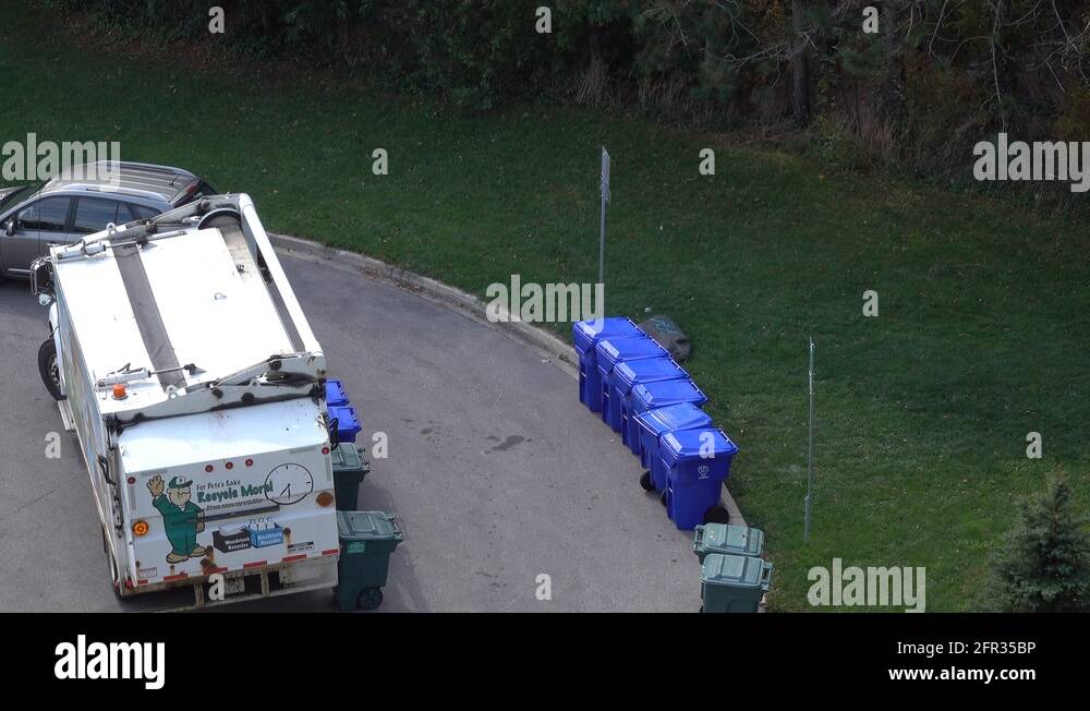 Garbage Truck Collecting Recycle Waste From Garbage Bins Stock Video