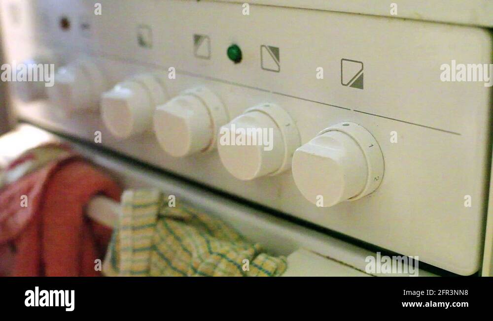 Turning on stove on highest heat level, close up, shallow DOF Stock
