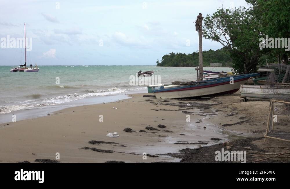 Jamaica coastal village fishing boat sandy beach 4K Stock Video Footage