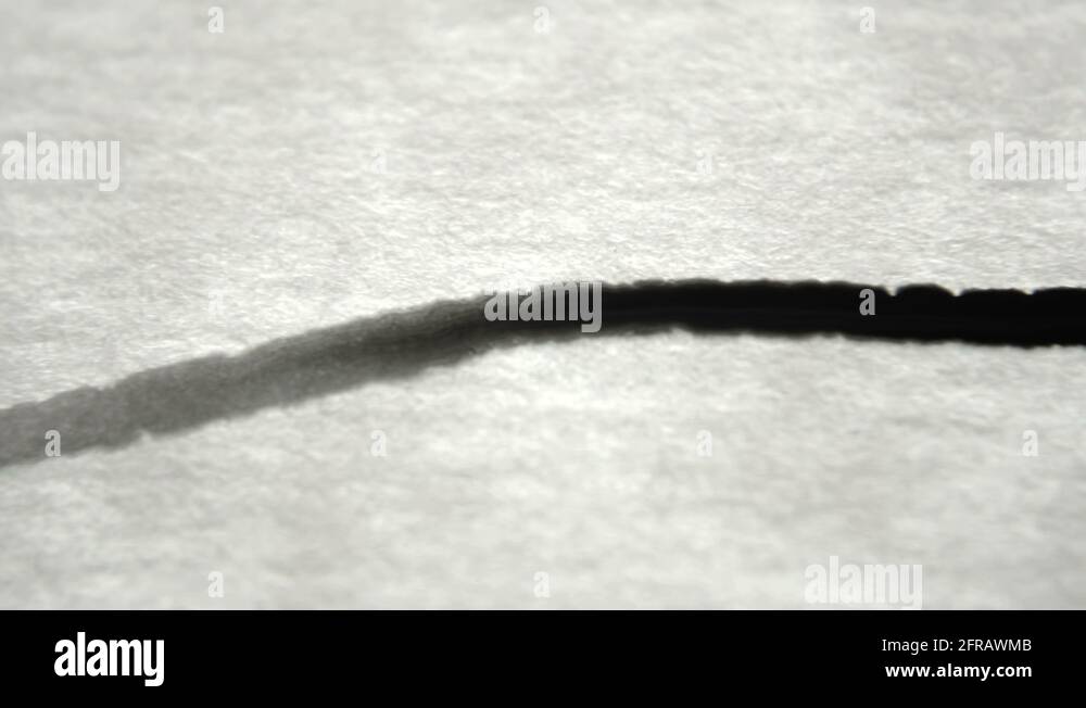 Thin Strip Of Ink Bleeding Into Parchment Paper Stock Video Footage Alamy