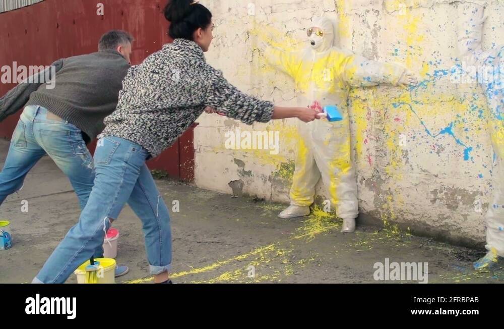 Free Artists, Street artist splashing paint on outer wall Stock Video
