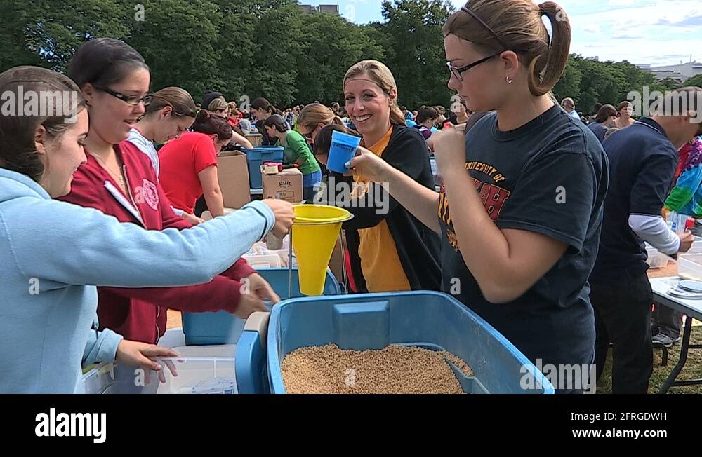 Students Volunteers pack charity food aid for homeless and starving in