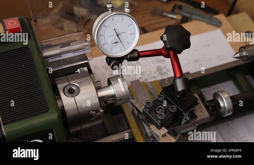 man using micrometer clock precision dial test indicator gauge scale on