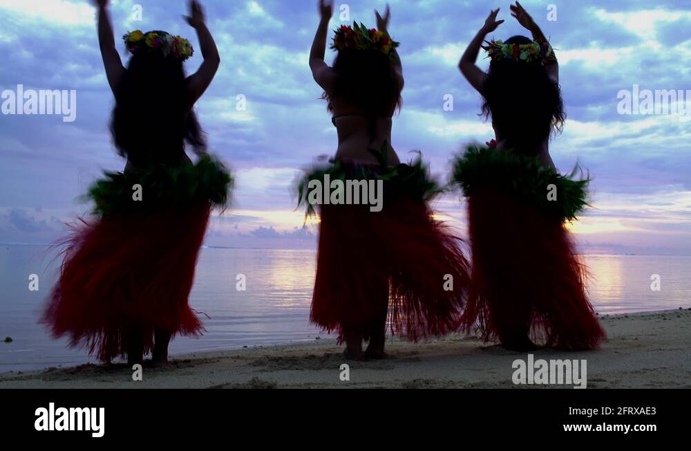 Polynesian girls in traditional grass skirts and flower headdress