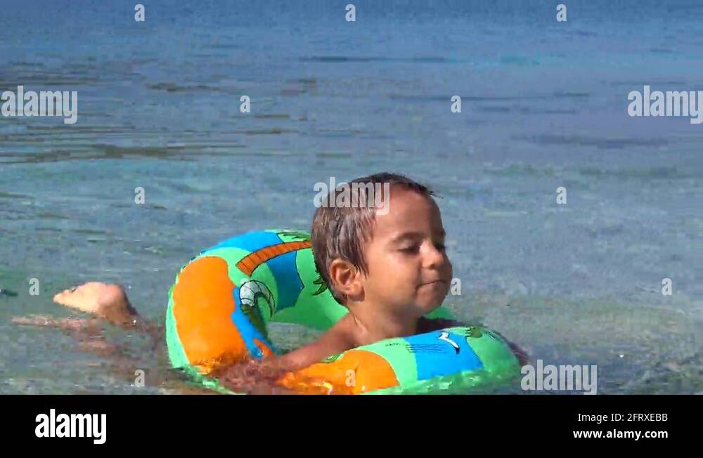 Cute little boy, playing in a rolling plastic cylinder ring, full with air,  outdoor Stock Photo - Alamy