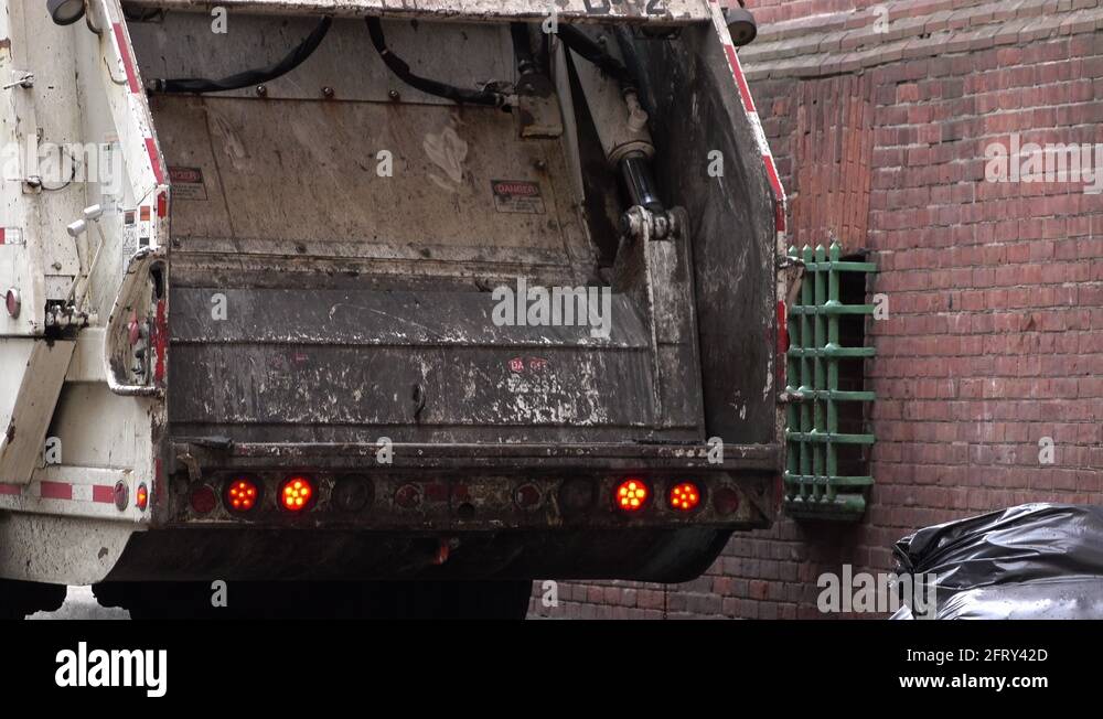 Garbage truck compacting trash 4k Stock Video Footage Alamy