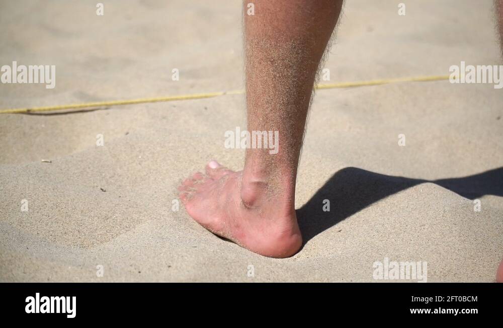 Men serving while playing 4man beach volleyball, slow motion Stock