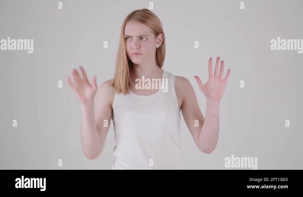 Woman comes into frame, tries to break invisible wall, then turns