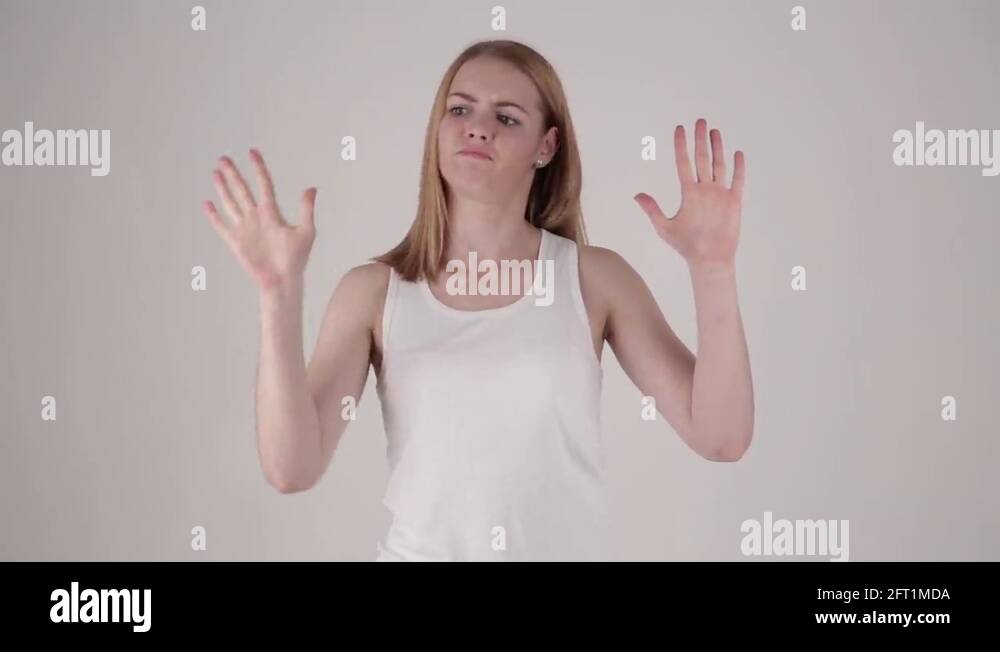 Woman comes into frame, tries to break invisible wall, then turns
