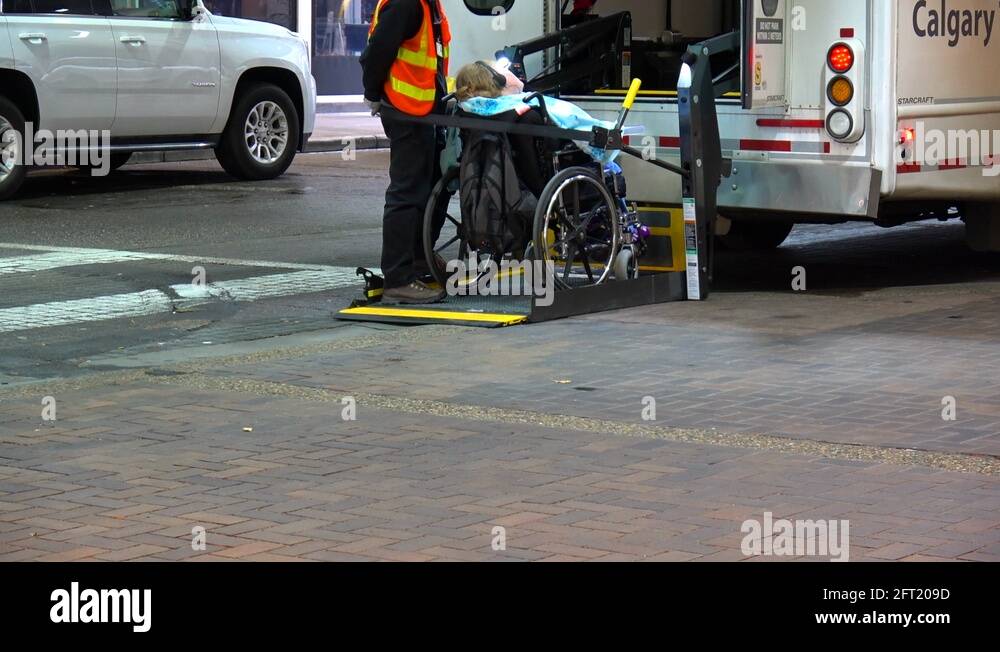 wheelchair-bound-person-with-disabilities-lifted-onto-a-handibus-stock