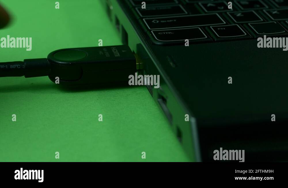 Hand Pulling Out Of Laptop Headphones Jack, Green Screen Stock Video