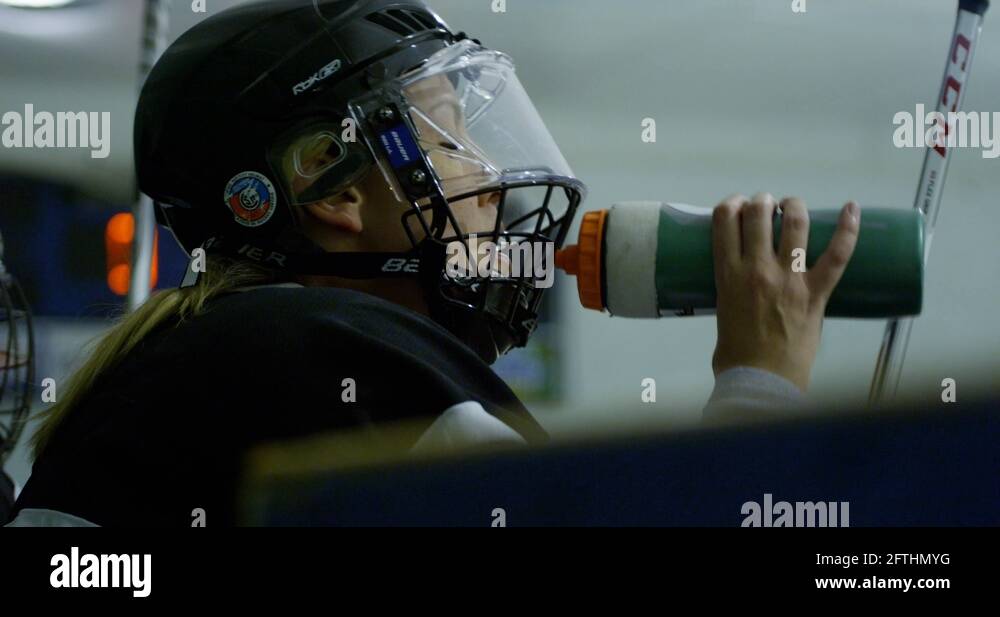 female hockey player drinking water slow motion 4k Stock Video Footage