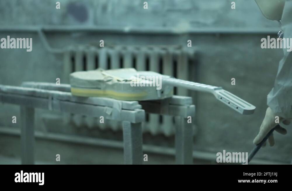 Painter using a paint sprayer for a guitar and creates props for the filming Stock Video Footage