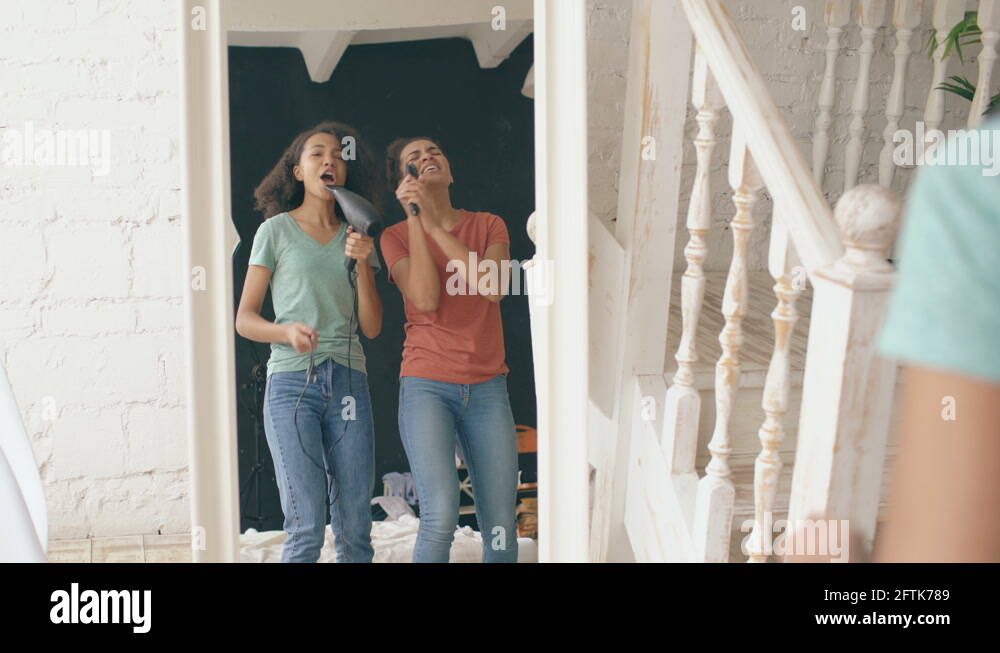 Mixed Race Young Funny Girls Dance Singing With Hairdryer And Comb In