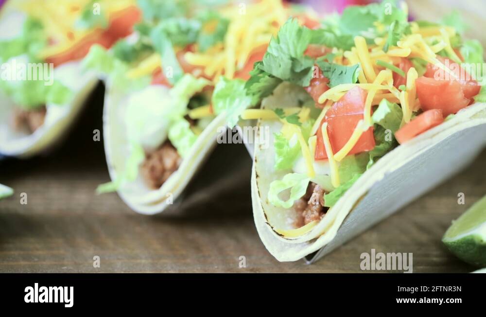 Ground beef tacos with romaine lettuce, diced tomatoes, and shredded