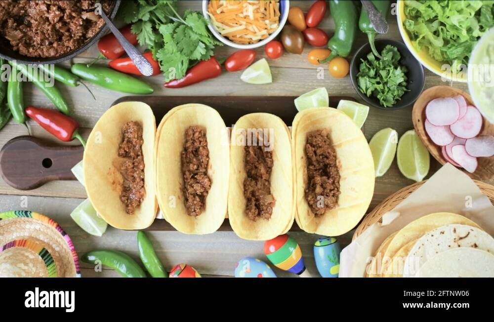 Ground beef tacos with romaine lettuce, diced tomatoes, radishes, and