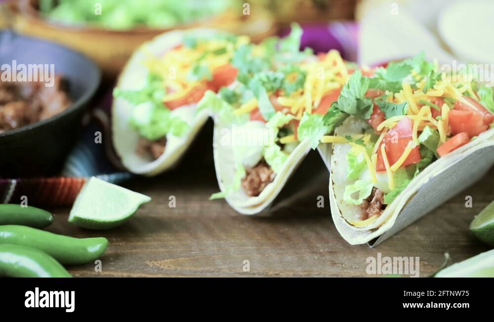 Ground beef tacos with romaine lettuce, diced tomatoes, and shredded