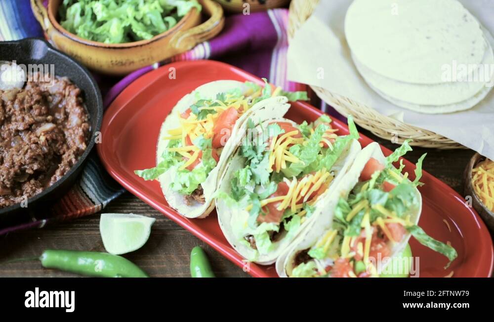 Ground beef tacos with romaine lettuce, diced tomatoes, and shredded
