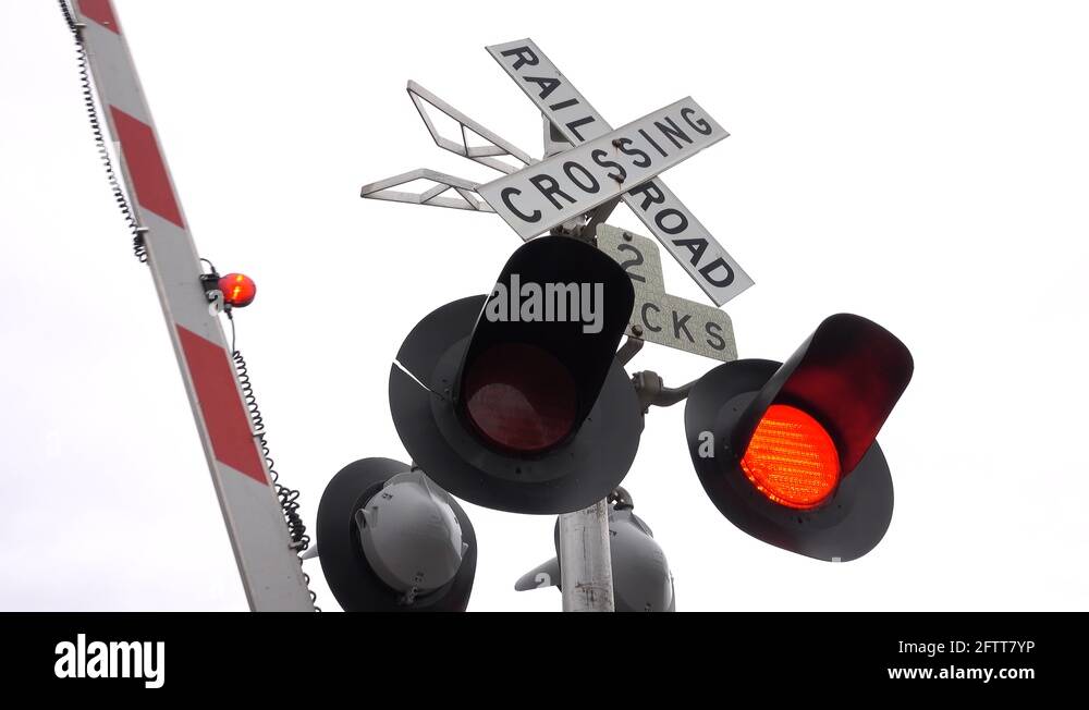 CLOSE UP Railway crossing sign, blinking red lights symbol and pole