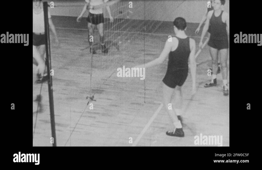 1940s Volleyball player touches net. Volleyball team practices and