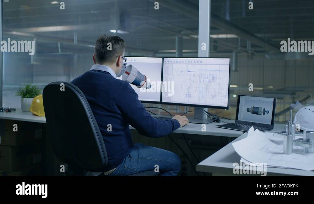 Chief Male Engineer Designs on 3D Model of a Turbine or Engine Part