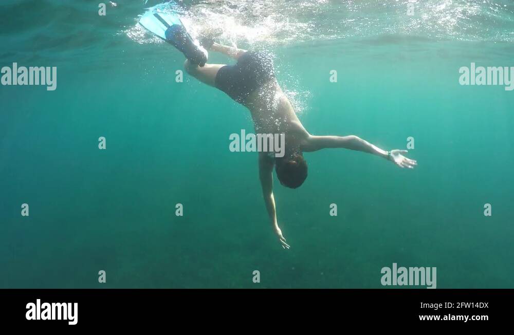 Swimmer in flippers dives into the sea Stock Video Footage - Alamy