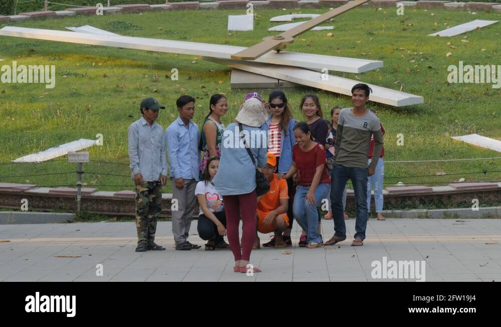 Cambodian tourists making group photo at big clock,Phnom Penh,Cambodia