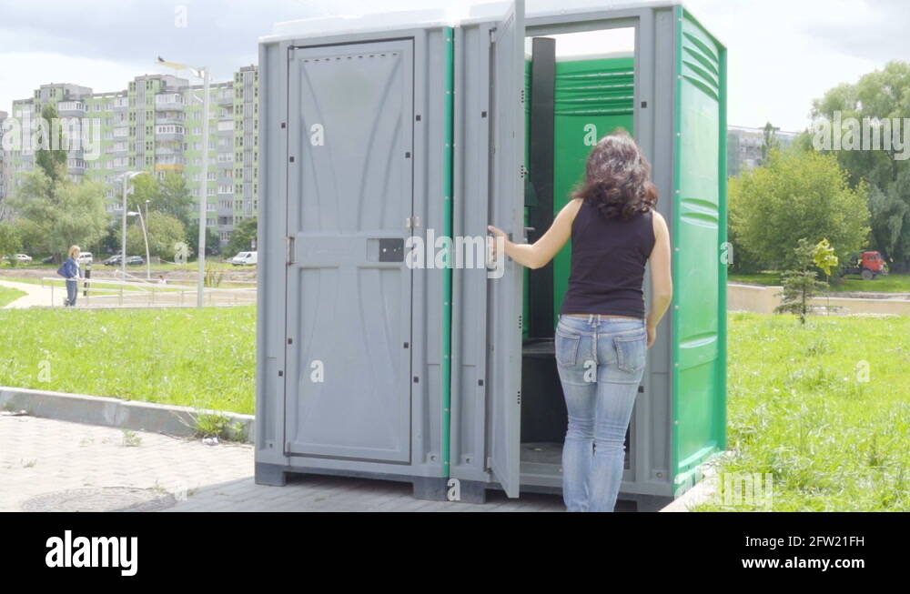 Paying public. Bio Toilet in the Park. Girl on biotoilet.