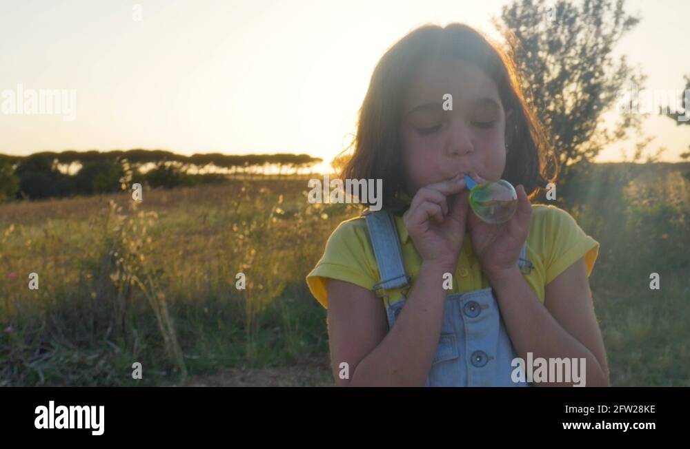 Two Little Girls playing with colorful bubble blower Stock Video ...