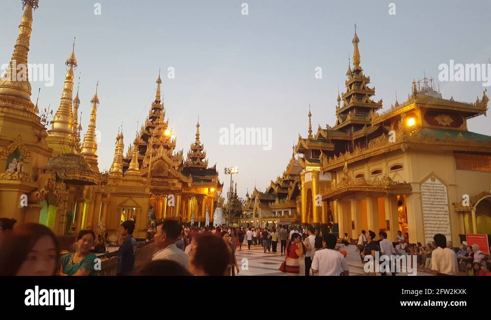 shwedagon-pagoda-compound-visitor-crowd-golden-structures-sundown