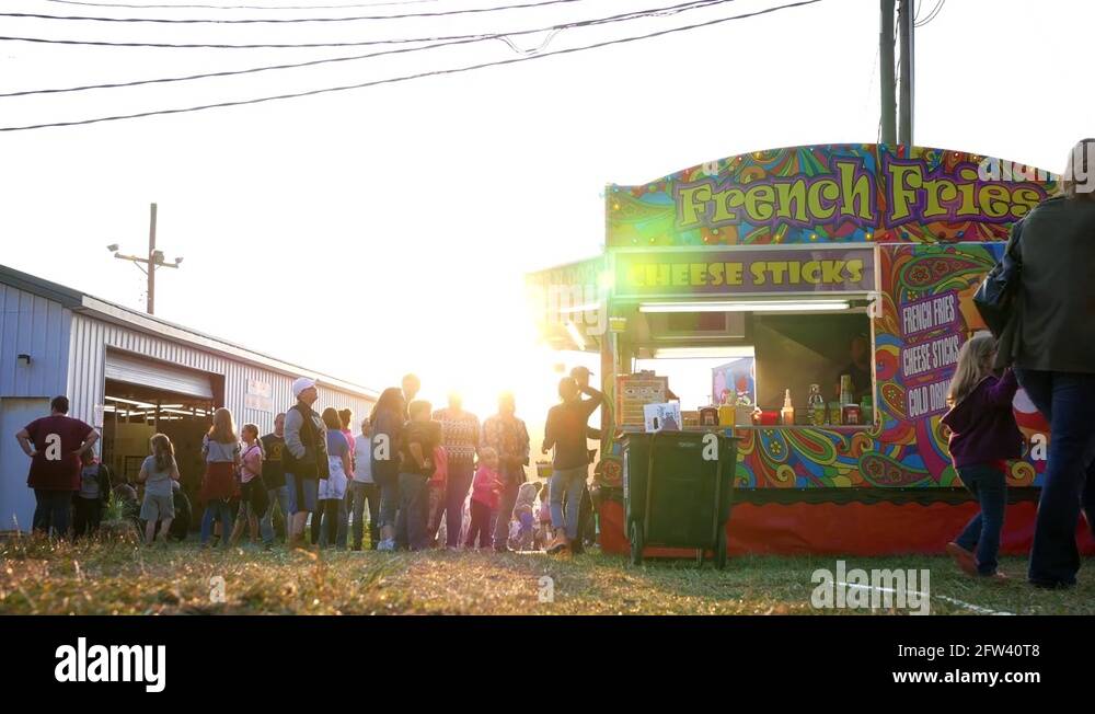 An establishing shot of a french fries concession stand at a county