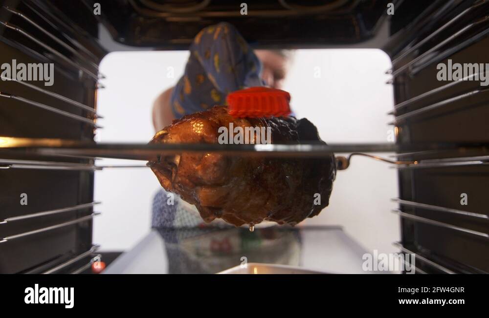 Grilling spit rotisserie pork sirloin roast in hot convection oven