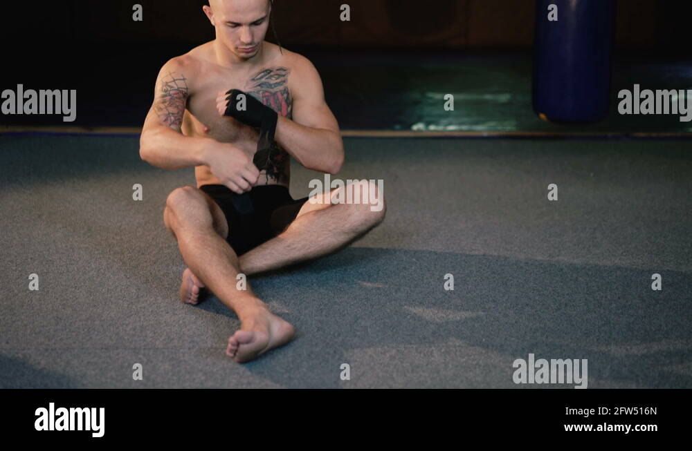 Free fighter wraps his hands with black hand wrap before the fight