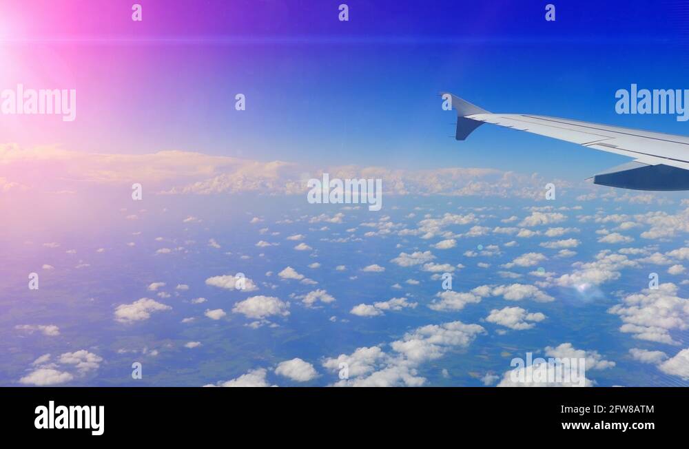 Lens Flare, View of Airplane Jet Wing Sky and Clouds from Window Blue ...