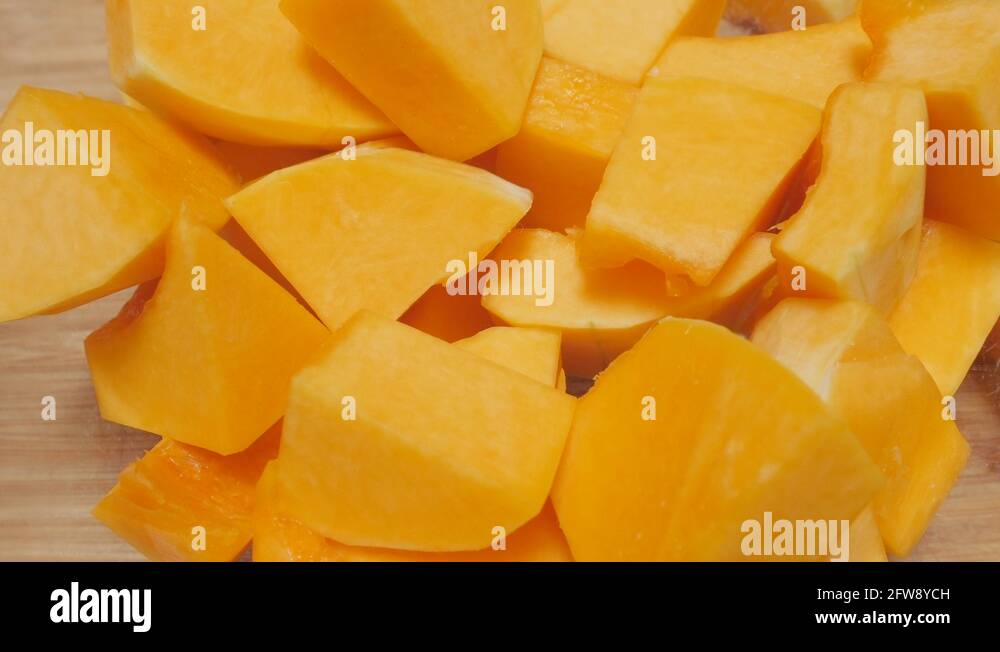 Cubes of Butternut Squash Dropping into a Glass Serving Bowl in 4k