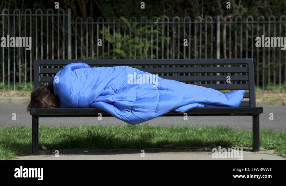 Homeless Man Sleeping on Park Bench Stock Video Footage - Alamy