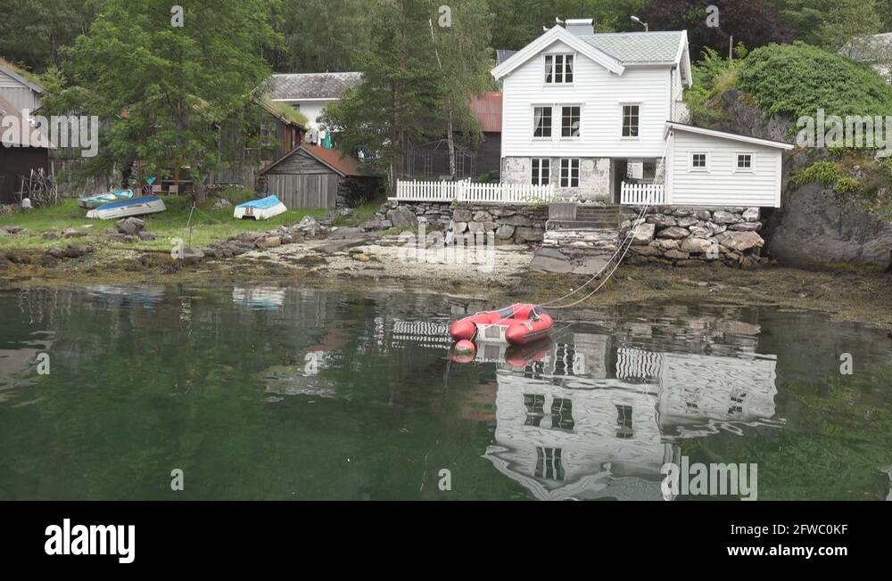 Norway Geiranger white Scandinavian house with its mirror image in