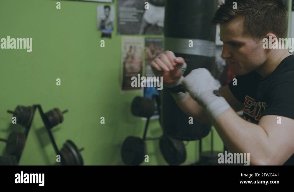 Young MMA fighter practices his left hook technique during a shadow