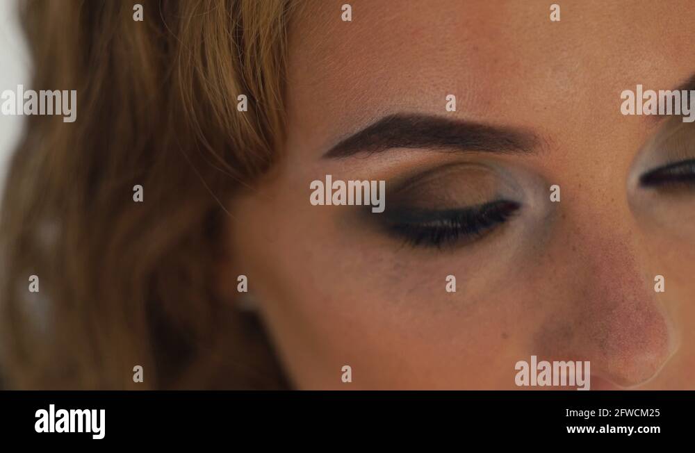 Face woman with perfect makeup blinking eyes close up. Portrait blinking woman Stock Video