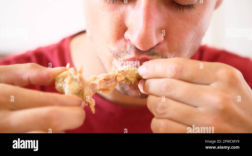 man eating fast food meat chicken wings unhealthy lifestyle bad diet